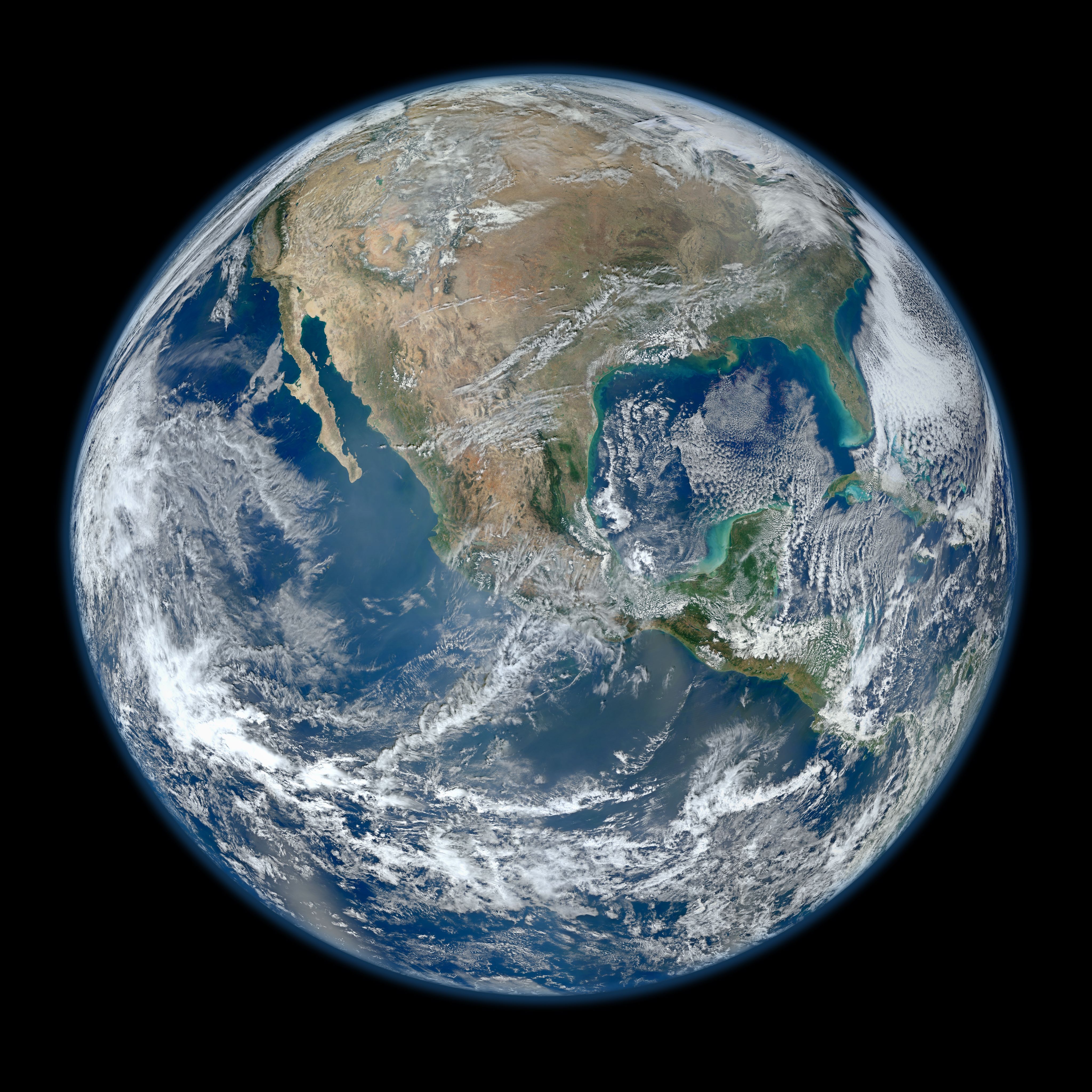 The curved horizon of Earth seen from space, blue ocean under swirling white cloud